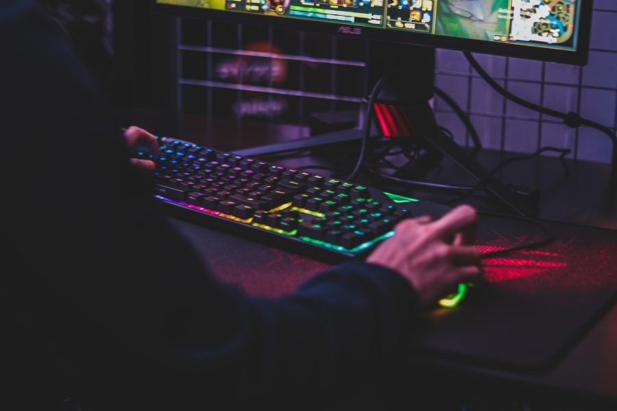 A person using a gaming mouse and keyboard